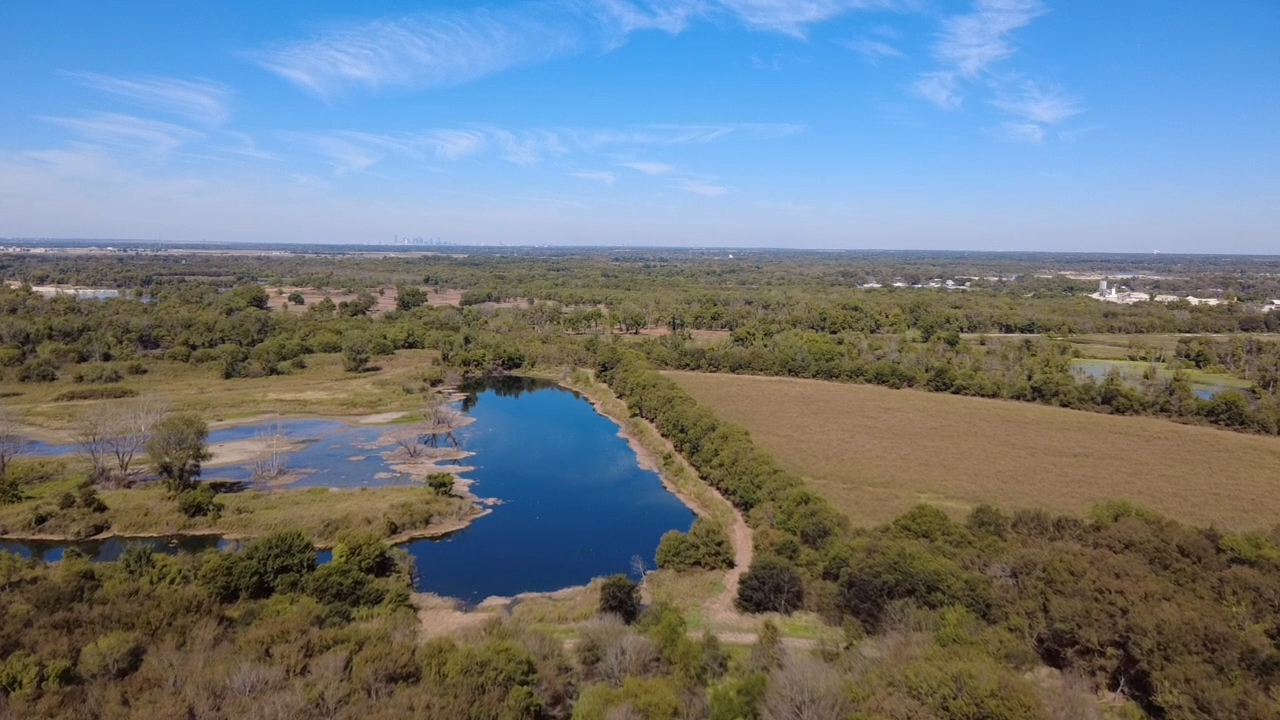 Scenic view of lush landscape with blue lake under clear sky