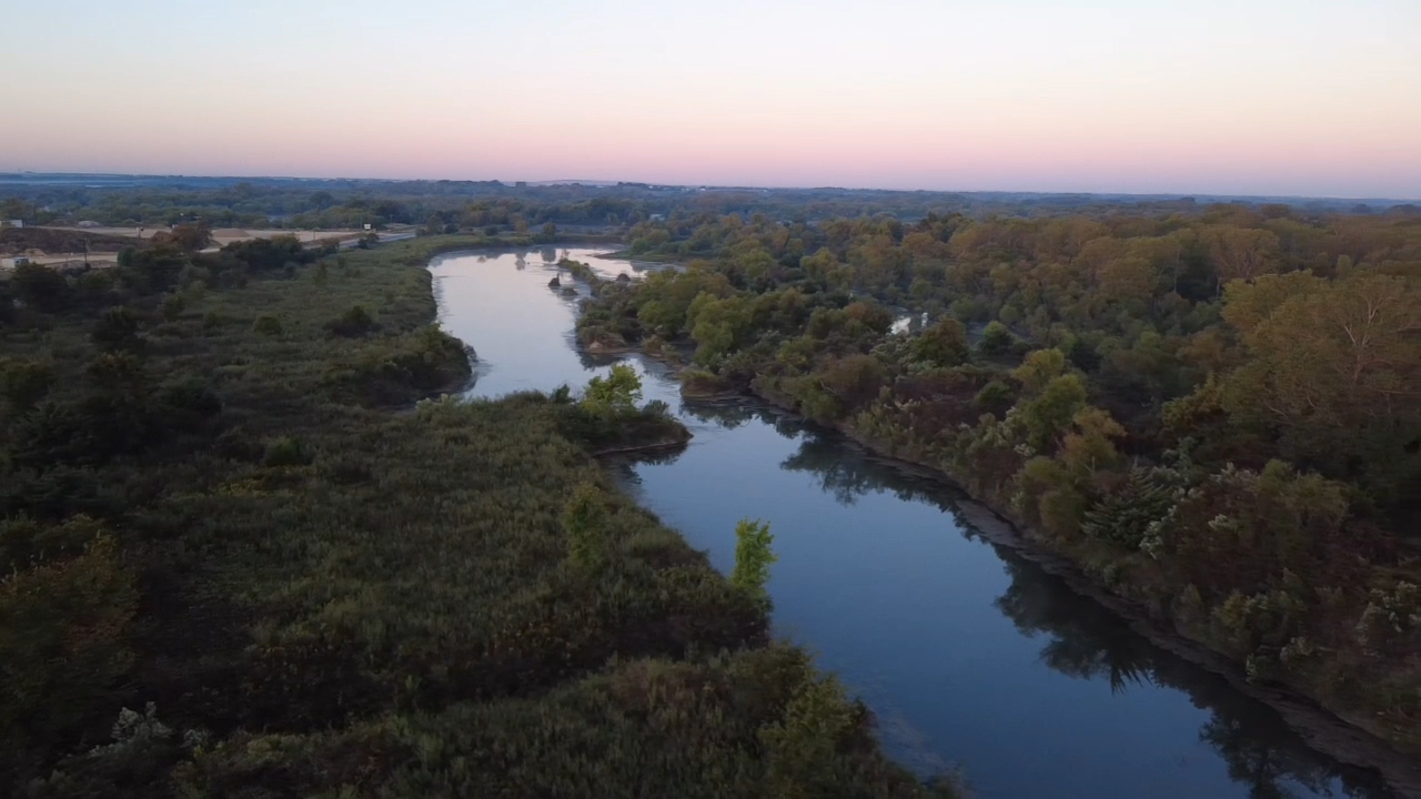 Scenic river view at sunset with lush green landscape
